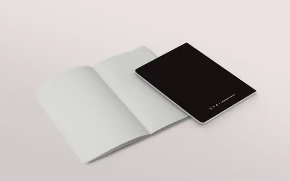 Immagine del quaderno di Antipatia Gratuita. In primo piano il quaderno chiuso con visibile il retro della copertina, in secondo piano il quaderno aperto